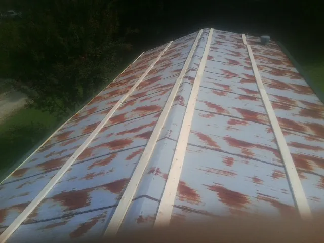 Rusted metal roof panels with new wood purlins before replacement — Storm Damage Roof Repair in Cooleemee by Roofing Brothers